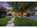 Beautifully landscaped front yard with stone pathway leading to the house, showcasing curb appeal at 1609 S Clayton St, Denver, CO 80210