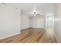 Spacious bedroom with wood-look floors, a ceiling fan, and natural light at 9462 Yampa Ct, Commerce City, CO 80022