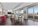 Elegant dining area with city views, modern chandelier, and comfortable seating at 4200 W 17Th Ave # 912, Denver, CO 80204