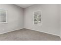 Neutral bedroom with carpet flooring and ample natural light from two windows at 725 Knox Ct, Denver, CO 80204