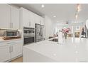 Stunning white kitchen with modern appliances and a large center island providing ample counter space and storage at 2415 Java Dr, Castle Rock, CO 80109