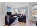 Cozy living room with comfortable seating, large windows, and stylish decor at 5110 E 64Th Ave, Commerce City, CO 80022