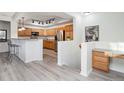 Open kitchen with island, stainless steel appliances, and wood cabinets at 3851 Stonebrush Dr # 11B, Littleton, CO 80126