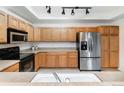 Modern kitchen featuring stainless steel appliances and ample cabinetry at 3851 Stonebrush Dr # 11B, Littleton, CO 80126