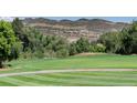 A meticulously maintained golf course fairway with scenic views of the surrounding mountains at 16223 River Haven Way, Morrison, CO 80465