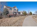 Charming back exterior view of a home with outdoor seating, a fenced yard, and a scenic walking path at 3395 Starry Night Loop, Castle Rock, CO 80109