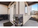 The front door displays a modern design with stone details, enhancing the property's curb appeal at 10512 Truckee St, Commerce City, CO 80022