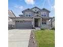 Charming two-story home features a landscaped front yard, inviting porch, and attached two-car garage at 690 Avena Dr, Elizabeth, CO 80107