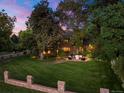 Beautiful home with a sprawling lawn, mature trees, and a cozy outdoor seating area with a fire pit at 4600 E 3Rd Ave, Denver, CO 80220