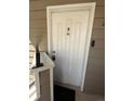 A white front door with security features provides a private entrance at 12478 W Nevada Pl # 207, Lakewood, CO 80228