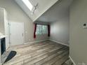 Bright living room featuring hardwood floors, high ceilings and natural light from the large window at 12478 W Nevada Pl # 207, Lakewood, CO 80228