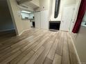 Spacious living room with fireplace, tile floors, and access to the kitchen at 12478 W Nevada Pl # 207, Lakewood, CO 80228