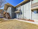 View of a two-story townhome with a private entrance and wood staircase to the second floor at 2269 Coronado Pkwy # C, Denver, CO 80229