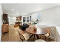 Open-concept dining area with modern chairs, wood table, and seamless flow to the living spaces at 2660 Julian St, Denver, CO 80211