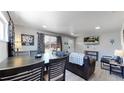 Open concept dining area with modern table and chairs at 7020 Avrum Dr, Denver, CO 80221