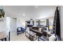 Spacious living room with a leather couch and modern coffee table at 7020 Avrum Dr, Denver, CO 80221