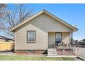 Charming single story home featuring vinyl siding, a cozy front porch and a well-kept front lawn at 6411 E 64Th Ave, Commerce City, CO 80022