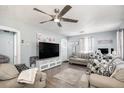 Comfortable living room with modern decor, a large TV, and plush seating at 6411 E 64Th Ave, Commerce City, CO 80022