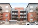 Apartment building featuring brick facade and multiple balconies on each unit at 1438 Little Raven St # 407, Denver, CO 80202