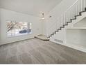 Bright living room featuring a staircase and large window at 18986 E 51St Pl, Denver, CO 80249