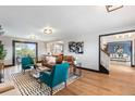 Bright living room featuring hardwood floors, black trim, and a comfortable seating arrangement at 6764 Hillridge Pl, Parker, CO 80134