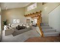Spacious living room with high ceilings, a beautiful staircase, and views into the dining room at 5 Ronnie Rd, Golden, CO 80403