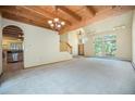 Open-concept living room featuring high ceilings, natural light, and seamless transitions to other living spaces at 5 Ronnie Rd, Golden, CO 80403