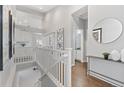 Hallway with stairway, white railings, hardwood flooring and a view to other rooms at 338 Sage Grouse Cir, Castle Rock, CO 80109