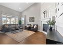 Bright living room with hardwood floors, fireplace, tall ceilings and large windows at 338 Sage Grouse Cir, Castle Rock, CO 80109