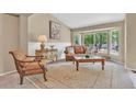 Bright living room featuring large bay windows and classic furnishings at 10877 W 55Th Ln, Arvada, CO 80002