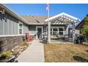 Inviting front porch with seating and a pergola, perfect for relaxing and enjoying the outdoors at 819 Meadow Ln, Palmer Lake, CO 80133