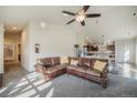 Spacious living room featuring a comfortable leather sofa and ample natural light at 819 Meadow Ln, Palmer Lake, CO 80133