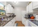 Efficient kitchen featuring white cabinets, modern appliances, and contrasting countertops at 2281 S Vaughn Way # 316A, Aurora, CO 80014