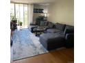 Spacious living room boasts great natural light, cozy furniture, and nice laminate floors at 2281 S Vaughn Way # 316A, Aurora, CO 80014