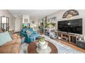 Inviting living room with a sofa, armchairs, a television, plants and a striking blue rug at 2281 S Vaughn Way # 316A, Aurora, CO 80014