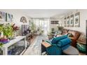 Comfortable living room with plants, a cozy couch, a television, and a sliding glass door to a balcony at 2281 S Vaughn Way # 316A, Aurora, CO 80014