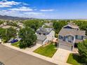 A neighborhood with well-maintained homes, mature trees, and mountain views at 9595 Elk Mountain Cir, Littleton, CO 80125
