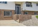Inviting front entrance features brick accents, gray front door, and well-maintained landscaping at 8925 Oakwood St, Westminster, CO 80031