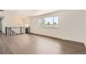 Bright living room with large windows, hardwood floors, and modern lighting fixtures at 8925 Oakwood St, Westminster, CO 80031