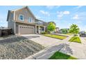 Beautiful two-story home with a wide driveway, manicured landscaping, and a charming front porch at 3074 Kestrel St, Brighton, CO 80601