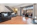 Inviting living room featuring a leather sofa and sliding doors to a private outdoor patio at 7995 E Mississippi Ave # A20, Denver, CO 80247