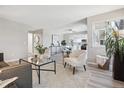 Bright living room boasts fresh, neutral paint, modern furniture and is open to the dining area at 1470 S Quebec Way # 83, Denver, CO 80231
