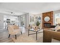 Stylish living area seamlessly flows into a modern kitchen, offering comfortable seating and a fireplace at 1470 S Quebec Way # 83, Denver, CO 80231