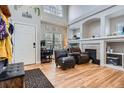 Inviting living room featuring a fireplace, high ceilings, hardwood floors, and neutral paint at 9615 Lansing Cir, Commerce City, CO 80022