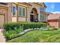 Manicured lawn with flower beds enhance the home's appeal at 5331 S Geneva Way, Englewood, CO 80111