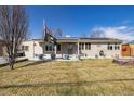 Well maintained single story home featuring solar panels, neutral colors, and mature trees at 4909 W Mississippi Ave, Denver, CO 80219