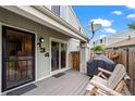 Back patio featuring a wooden rocking bench, grill and privacy fence next to sliding glass door at 8738 Chase Dr # 134, Arvada, CO 80003
