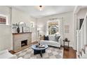 Cozy living room featuring a fireplace, modern decor, and hardwood floors with natural light at 4130 Umatilla St, Denver, CO 80211