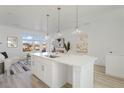 Bright kitchen featuring a large island and a view of the neighborhood through the window at 8 Oneida Ct, Denver, CO 80230