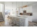 Open kitchen layout with large center island, modern cabinetry, and bar stool seating at 8 Oneida Ct, Denver, CO 80230